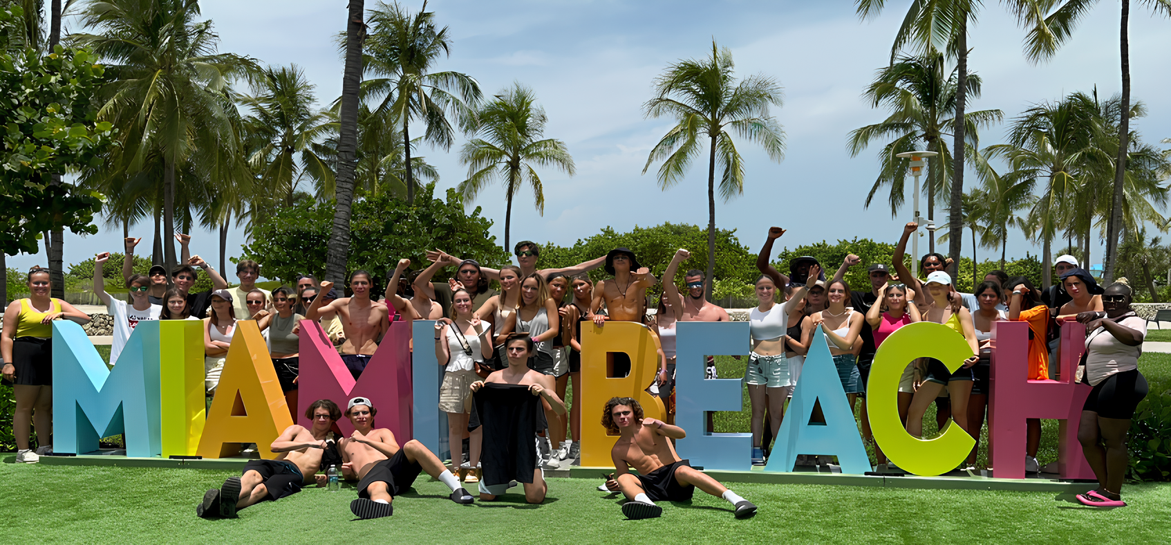 Student group at the Miami Beach sign