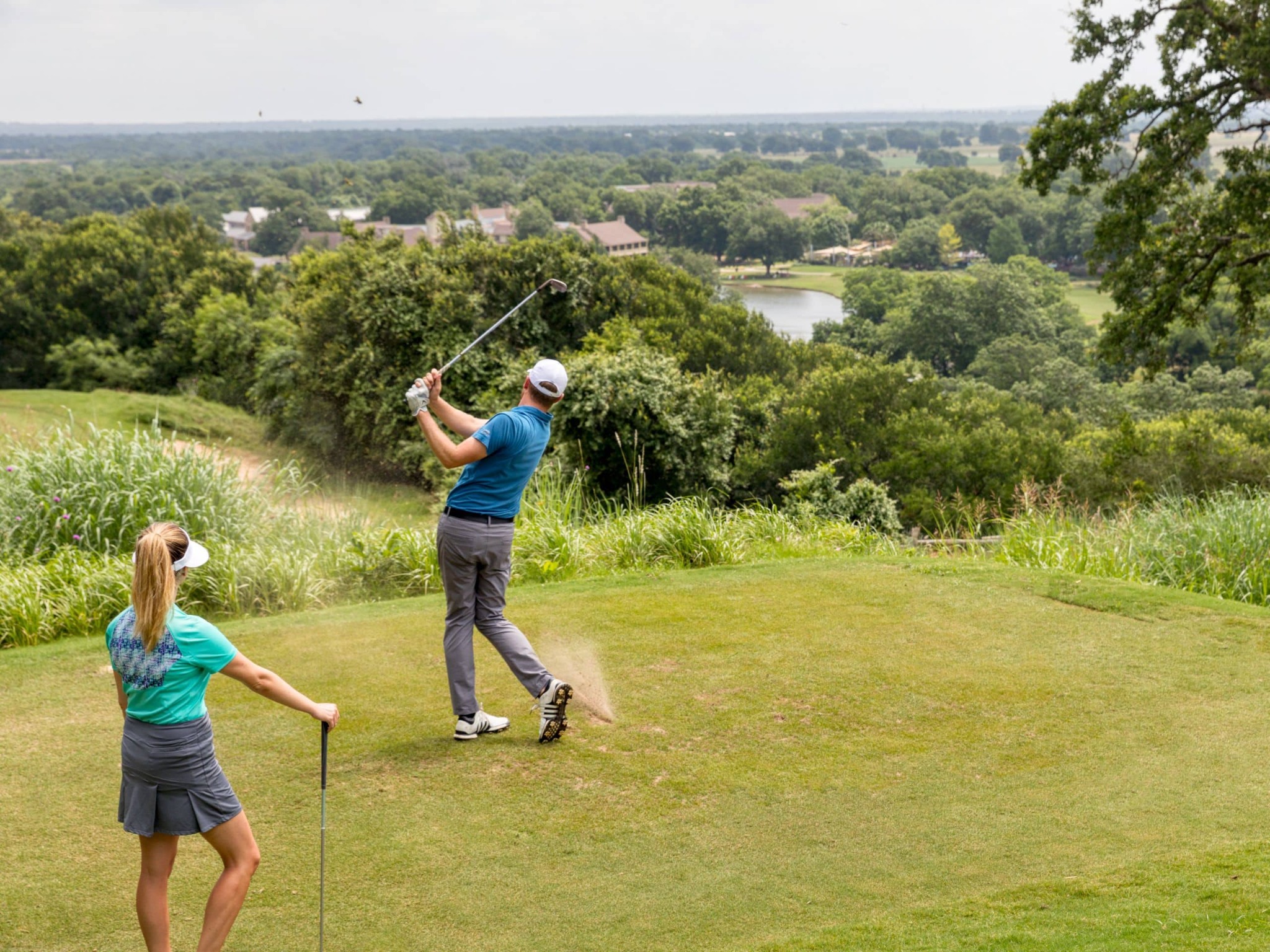 Golfers enjoying a green course in the Texas Hill Country
