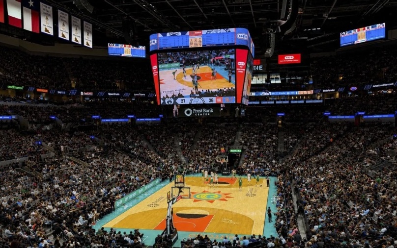 Basketball game viewed from the upper level of a packed Texas arena