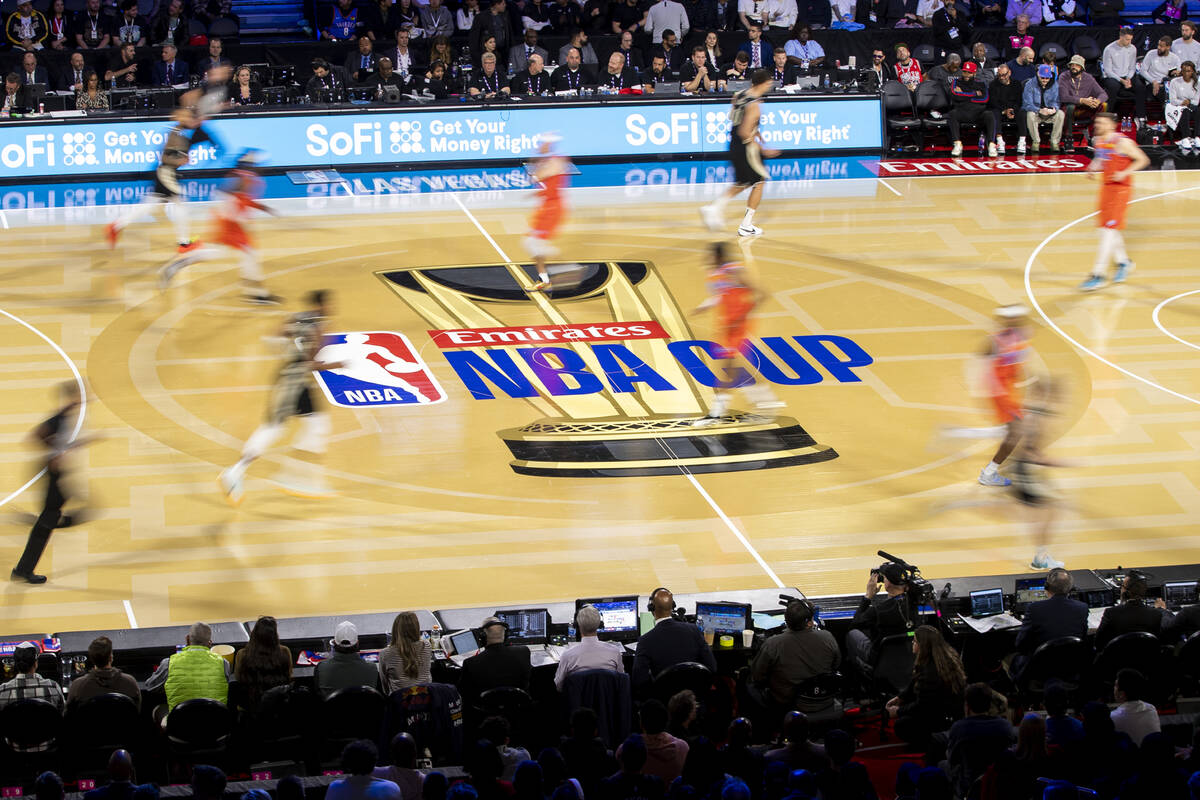 Basketball players on a court branded NBA Cup during a televised game