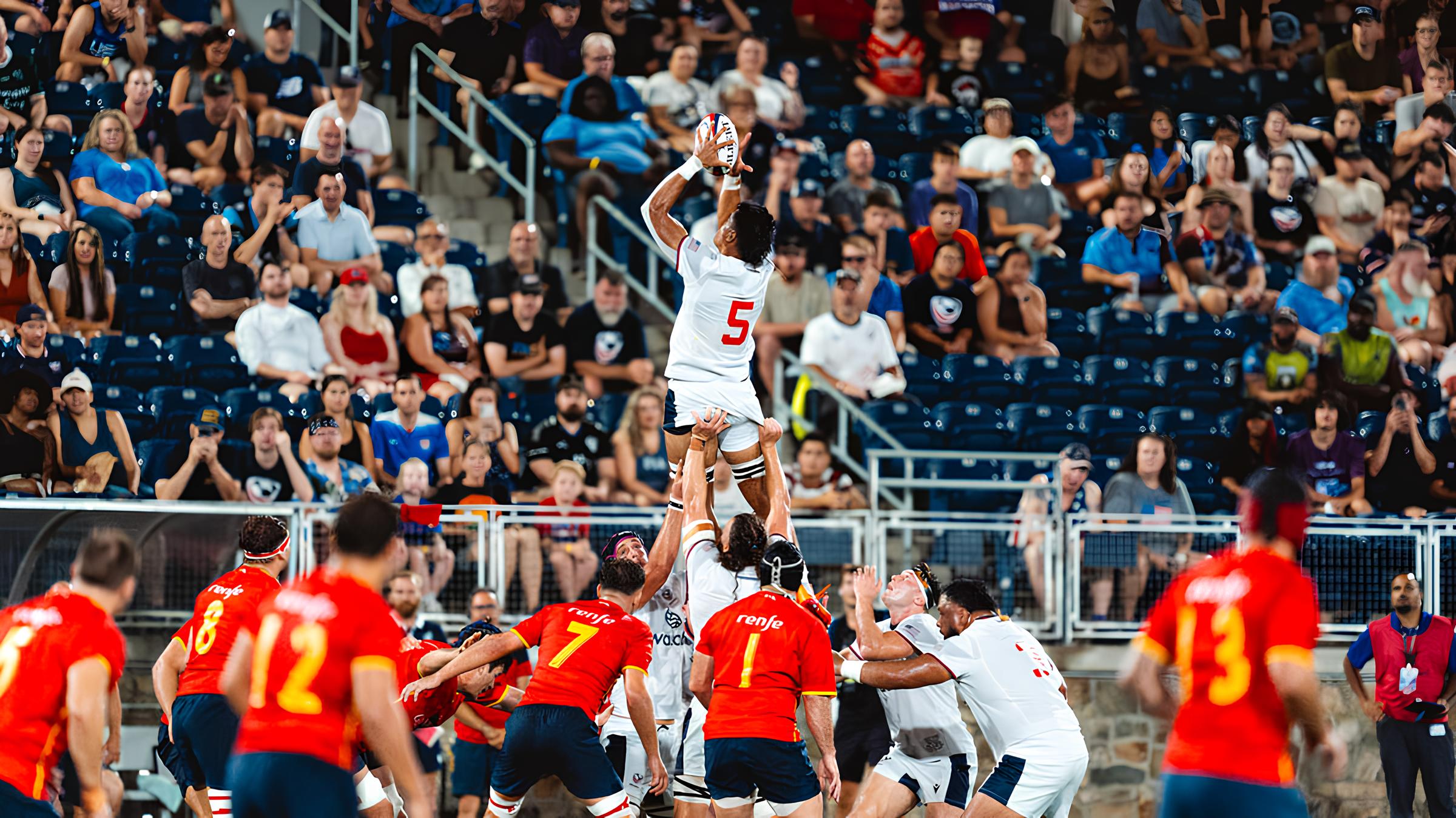 International rugby players contesting a lineout in a crowded stadium