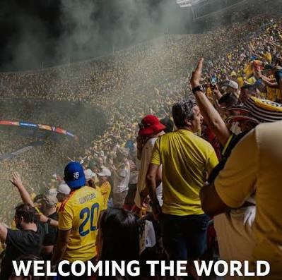 Rugby supporters entering an event with a Welcome to the World banner