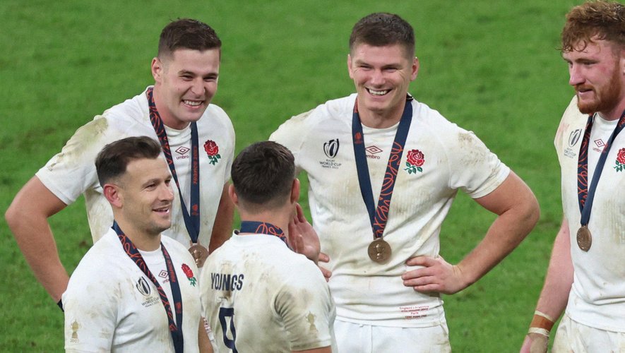 Rugby players wearing medals and celebrating after a match